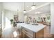 Open-concept kitchen with island, dining area, and living room, featuring natural light and modern finishes at 5108 Potter Rd, Matthews, NC 28104