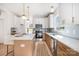 Bright kitchen with white cabinets, stainless steel appliances, and a quartz countertop island with pendant lighting at 5108 Potter Rd, Matthews, NC 28104