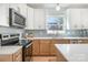 This kitchen features white cabinets, stainless steel appliances, subway tile backsplash, and a quartz countertop at 5108 Potter Rd, Matthews, NC 28104