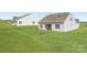 Well-maintained lawn with a screened-in porch in the backyard of this charming home at 5926 Oak Branch Cir, Maiden, NC 28650