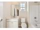 Bathroom featuring white vanity, toilet, shower, and a window for natural light at 5926 Oak Branch Cir, Maiden, NC 28650