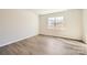 Bright, airy bedroom with large window and neutral decor, hardwood floors at 5926 Oak Branch Cir, Maiden, NC 28650