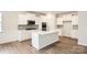 Modern kitchen with stainless steel appliances, large island, and white cabinetry at 5926 Oak Branch Cir, Maiden, NC 28650
