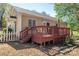 Exterior of home featuring a wooden back deck with dining and bbq areas and mature trees at 602 S Church St, Lowell, NC 28098
