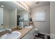 Bathroom featuring double vanity, neutral walls, and natural lighting at 602 S Church St, Lowell, NC 28098
