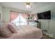 Bedroom featuring neutral walls, plush carpet, and a bed with soft pink bedding at 602 S Church St, Lowell, NC 28098