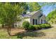 Charming single-story home with beige siding, black shutters, mature landscaping, and a well-maintained lawn at 602 S Church St, Lowell, NC 28098