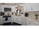 Bright kitchen with white cabinets, stainless steel appliances, and decorative pendant lights at 602 S Church St, Lowell, NC 28098