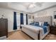 Comfortable main bedroom with a tufted headboard, ceiling fan, and blue accents at 602 S Church St, Lowell, NC 28098