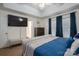 Bright main bedroom featuring a decorative ceiling fan and a seating area at 602 S Church St, Lowell, NC 28098