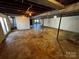 Unfinished basement with exposed support beams, open space, and good lighting at 614 Hazelwood Dr, Albemarle, NC 28001