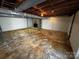 Spacious unfinished basement with stone fireplace and exposed utilities at 614 Hazelwood Dr, Albemarle, NC 28001
