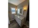 Updated bathroom with a stone countertop, new fixtures, and a window at 614 Hazelwood Dr, Albemarle, NC 28001