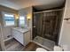 Updated bathroom with a stone countertop, tiled shower, and new fixtures at 614 Hazelwood Dr, Albemarle, NC 28001