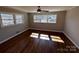The spacious bedroom has wood floors, natural light and a ceiling fan at 614 Hazelwood Dr, Albemarle, NC 28001