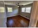 This bedroom has hardwood floors, neutral paint and a ceiling fan at 614 Hazelwood Dr, Albemarle, NC 28001