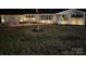 Charming home exterior at night, featuring manicured lawn and decorative lighting at 614 Hazelwood Dr, Albemarle, NC 28001