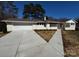 Charming one-story home with white painted brick, concrete driveway, and brown roof at 614 Hazelwood Dr, Albemarle, NC 28001