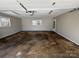 Spacious two car garage with overhead lighting and natural light from a window at 614 Hazelwood Dr, Albemarle, NC 28001