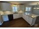Bright kitchen features white cabinets, modern appliances, and granite countertops at 614 Hazelwood Dr, Albemarle, NC 28001