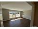 Bright living room featuring hardwood floors, neutral paint, and large windows at 614 Hazelwood Dr, Albemarle, NC 28001