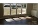 Bright living room featuring hardwood floors, neutral paint, built-in shelving, and large windows at 614 Hazelwood Dr, Albemarle, NC 28001