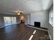 Bright living room featuring hardwood floors, brick fireplace, ceiling fan and access to the patio at 614 Hazelwood Dr, Albemarle, NC 28001