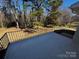Outdoor patio with metal railing, a concrete surface, and a view of trees at 614 Hazelwood Dr, Albemarle, NC 28001