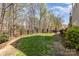 Lush backyard featuring a grassy lawn, privacy fence, and mature trees for a serene outdoor retreat at 717 Barossa Valley Nw Dr, Concord, NC 28027