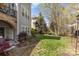 A well-maintained backyard with mature trees, a grassy lawn, and a patio at 717 Barossa Valley Nw Dr, Concord, NC 28027