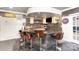 Basement bar area featuring granite countertop, custom cabinets, and seating for four at 717 Barossa Valley Nw Dr, Concord, NC 28027