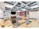 Basement entertainment area with coffered ceiling, large sectional, and media center at 717 Barossa Valley Nw Dr, Concord, NC 28027