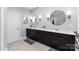 Spacious bathroom featuring dual vanities with dark cabinets and modern fixtures at 717 Barossa Valley Nw Dr, Concord, NC 28027