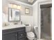 Cozy bathroom with a combination shower and tub, gray cabinet, and white subway tile at 717 Barossa Valley Nw Dr, Concord, NC 28027