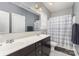 Well-lit bathroom with double vanity, framed mirror, and shower curtain at 717 Barossa Valley Nw Dr, Concord, NC 28027