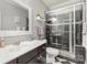 Modern bathroom featuring sleek black and white tiles, glass shower, and stylish vanity at 717 Barossa Valley Nw Dr, Concord, NC 28027