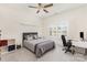 Cozy bedroom with a comfortable bed, desk, and bright natural light through shuttered windows at 717 Barossa Valley Nw Dr, Concord, NC 28027
