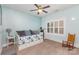 Serene bedroom with light blue walls, a comfortable daybed, and a sunlit window at 717 Barossa Valley Nw Dr, Concord, NC 28027