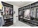 Walk-in closet with extensive shelving, hanging racks, and ample storage space for clothes and accessories at 717 Barossa Valley Nw Dr, Concord, NC 28027