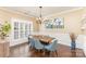 Dining room featuring blue upholstered chairs, plantation shutters, and neutral walls at 717 Barossa Valley Nw Dr, Concord, NC 28027