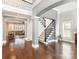 Open foyer with dark wood floors, neutral walls, and a staircase with wrought iron spindles at 717 Barossa Valley Nw Dr, Concord, NC 28027