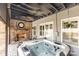 Covered patio with hot tub and brick fireplace, perfect for outdoor relaxation at 717 Barossa Valley Nw Dr, Concord, NC 28027