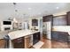 Stunning kitchen with granite counters, stainless appliances, and rich dark wood cabinetry at 717 Barossa Valley Nw Dr, Concord, NC 28027