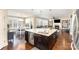 Open concept kitchen with a large island, granite countertop, and seamless flow to the dining and living areas at 717 Barossa Valley Nw Dr, Concord, NC 28027