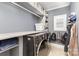 Modern laundry room with gray cabinets, shelving, and front-load washer and dryer at 717 Barossa Valley Nw Dr, Concord, NC 28027