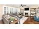 Spacious living room with a fireplace, a large sectional sofa, and plantation shutters at 717 Barossa Valley Nw Dr, Concord, NC 28027