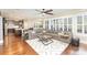 Open-concept living room with a large sectional sofa, dark wood floors, and a view of the kitchen at 717 Barossa Valley Nw Dr, Concord, NC 28027