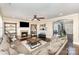 Cozy living room with a fireplace, a large sectional sofa, and dark wood floors at 717 Barossa Valley Nw Dr, Concord, NC 28027