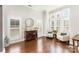 Sitting room with plantation shutters, neutral walls, dark wood floors, and comfortable seating at 717 Barossa Valley Nw Dr, Concord, NC 28027