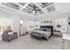 Elegant main bedroom boasts a tray ceiling, large windows, and a cozy sitting area at 717 Barossa Valley Nw Dr, Concord, NC 28027